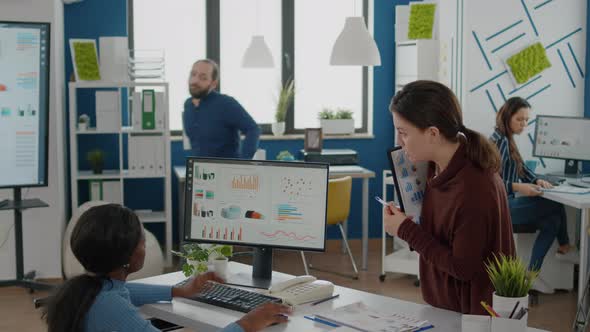 Businesswomen Discussing Financial Strategy Looking on Computer alt