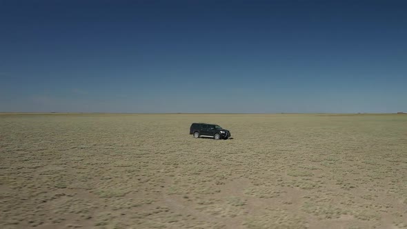 Black Pickup In Middle Of Plains  alt