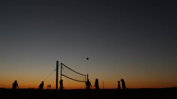 Volleyball Net Silhouette on Beach Court at Sunset Players on California Coast