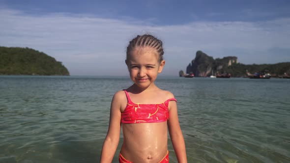 Little Girl in the Sea. Portrait of Adorable Kid in Swimsuit on Her Summer Tropical Holidays in 
