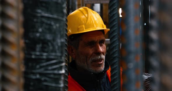 Worker Knitting Metal Rods Bars Into alt