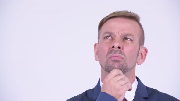 Head Shot of Happy Blonde Businessman Smiling While Thinking alt