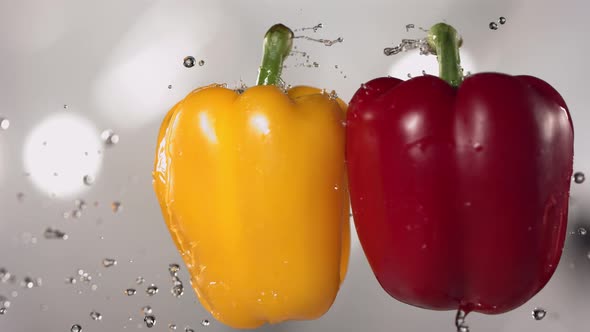 Flying Colored Red and Yellow Peppers Collision in the Air in Slow Motion alt