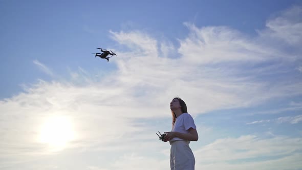 A Woman Learns To Control a Drone. Training To Fly on a Quadcopter in a Safe Place