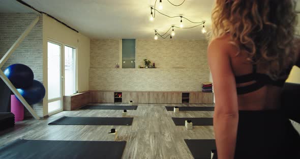 Modern Yoga Studio Lady Coming in To Start Her alt