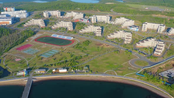 A Modern Complex of Buildings on the Shore of the Bay Surrounded By a Large Park alt