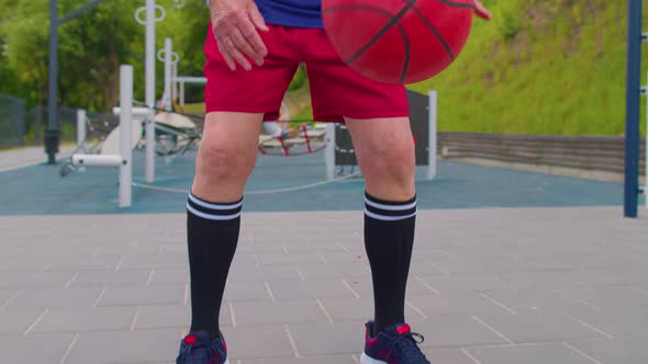 Senior Old Sportsman Grandfather Athlete Playing Practicing Dribbling with Ball on Basketball Court alt