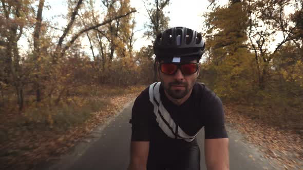 Cyclist Taking Selfie Video When Riding On Bicycle. Close Up Cyclist In Motion On Trail Road. alt