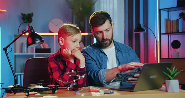 Father Talking with His Teen Son About Electronic Panel with Components and Reading Information alt
