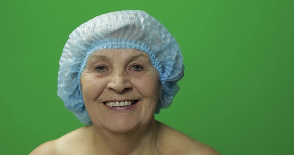 Elderly Female in Protective Hat. Doctor Making Facial Injections for Patient alt