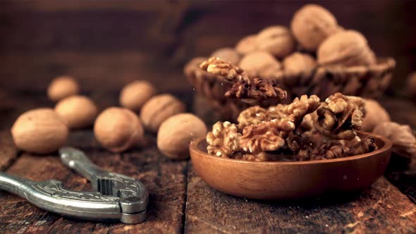 Super Slow Motion Plate with Walnuts Falls on the Table alt