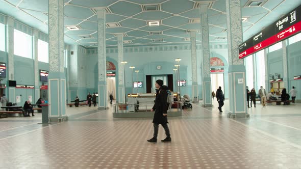 A Young Passenger Walks Through the Station