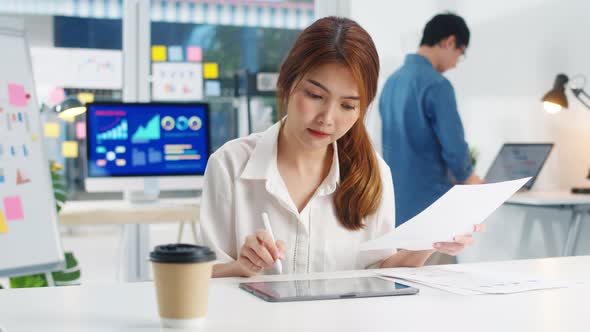 Asia young businesswoman smart writing and using pen with digital tablet computer.