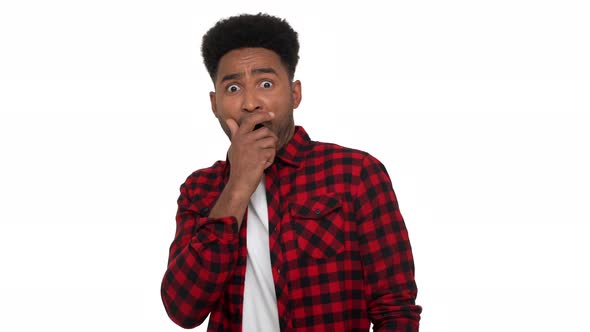 Portrait of Mixedrace Man with African Hairdo in Trendy Red Plaid Shirt Being Frightened Covering alt