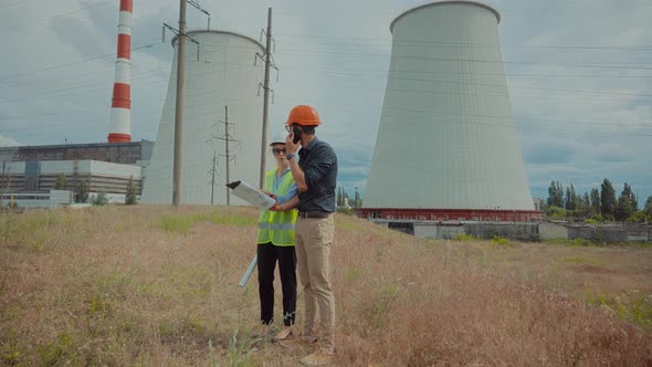 Electrical Engineer In Helmet Power Line. Constructor Checking High Voltage Sensor Power Line Wire. alt