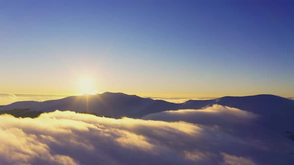 Wonderful View of Extraordinary Cloudy Valley and Bright Orange Sunset alt