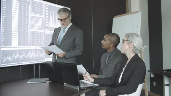 Corporate Trainer Giving Seminar To New Employee alt