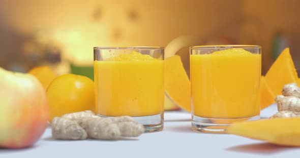 Pumpkin and Ginger Smoothie is Poured Into Glasses Against a Background of Fresh Vegetables and alt