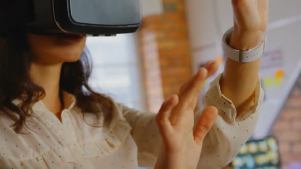 Businesswoman trying helmet virtual reality in office. alt