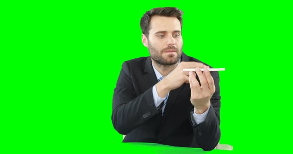 Businessman with mobile phone touching digital screen alt