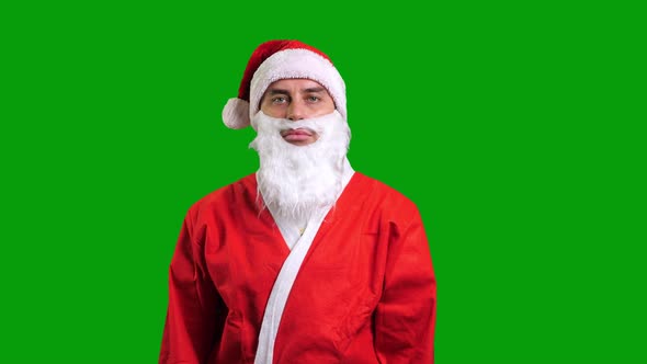 Santa Claus in Red Costume Standing and Smiling on Green Chroma Key Background alt