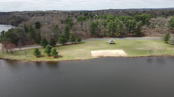 Aerial of midwest park along lake in midwest Wisconsin on a cloudy day in autumn.