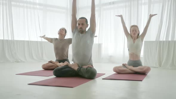 Young Sporty Attractive People Practicing Yoga Lesson with Instructor alt
