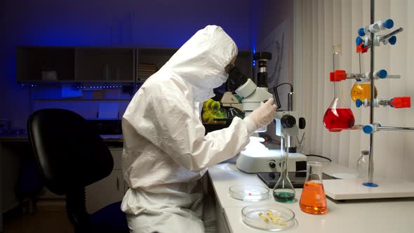 Scientist Examining Samples with Microscope