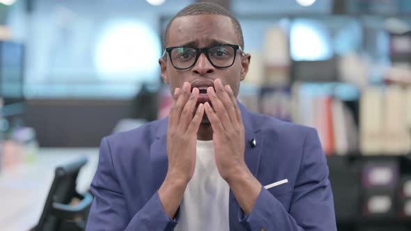 Portrait of Disappointed African Businessman Reacting Loss alt