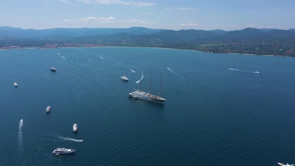 Aerial view of a yacht and many boats along the coast, France. alt