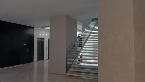 Walking upstairs from hotel lobby alt