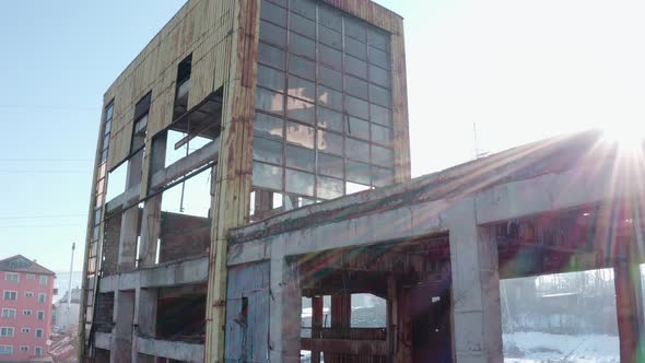 Drone view of abandoned industrial factory at Vlahita with snow, Romania. Aerial ascending alt