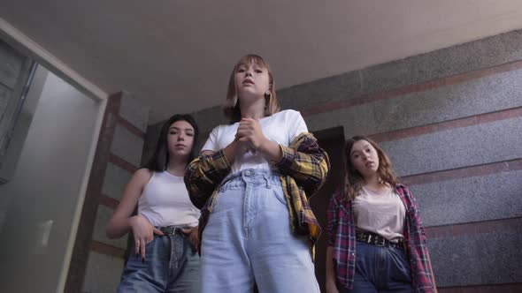 Bottom View of Three Aggressive Caucasian Teenage Girls Talking Threatening Someone alt