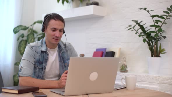 Portrait of a Man Working at Home on Some Project He Is Sitting at a Table Drawing Ideas Notebook alt