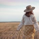 Unrecognizable Ethnic Woman Walking in Wheat Field After Harvesting - VideoHive Item for Sale