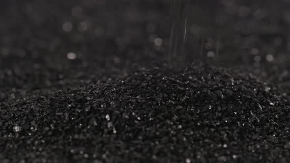 Pouring Black Coconut Charcoal Closeup Slomo Activated Carbon Small Fraction alt