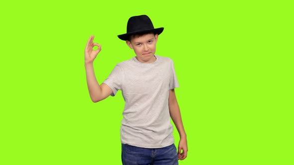 Teenage Boy in White T-shirt and Black Hat Showing OK Sign