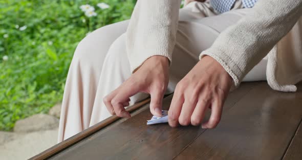 Woman Fold a Paper to Make Crane Origami in Japanese House alt