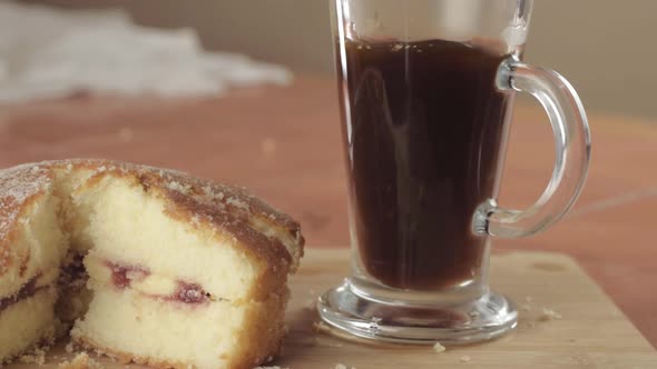 Coffee and slice of Victoria sponge cake with hot drink medium shot alt