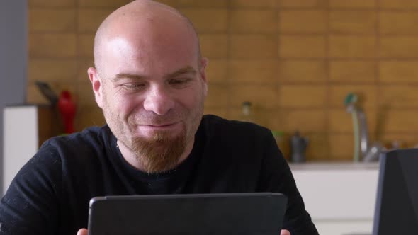 Lockdown, stay at home - young man talking in video call with his tablet alt
