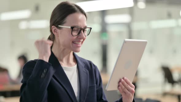 Portrait of Excited Young Businesswoman having Success on Tablet alt