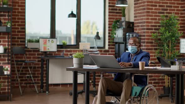 Sales Consultant Sitting in Wheelchair and Working on Business alt