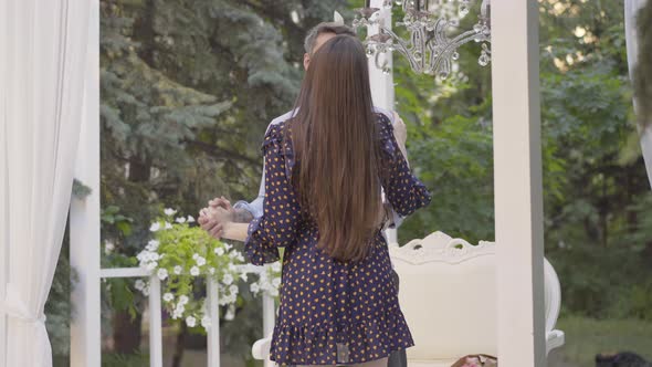 Portrait of Happy Couple Dancing in Romantic Pavilion Outdoors. Loving Caucasian Man and Woman alt