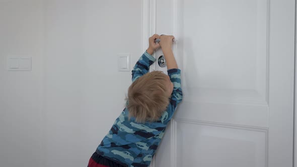 Moody Baby Kid Boy Pulls Door Handle To Toilet And Calls His Mother alt