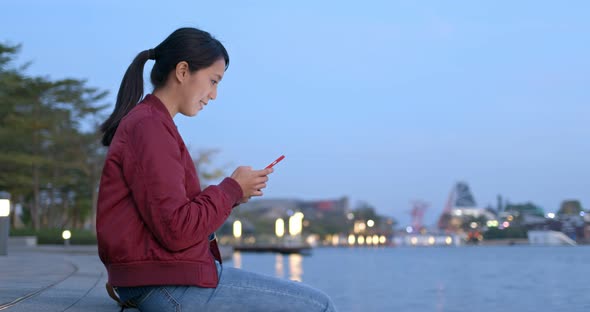 Woman use cellphone online in the evening alt