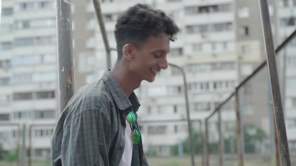Side View Portrait of Laughing African American Man Turning To Camera and Making Suicide Gesture alt