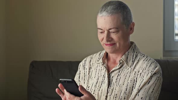 Senior Woman Playing an Online Game on Smartphone