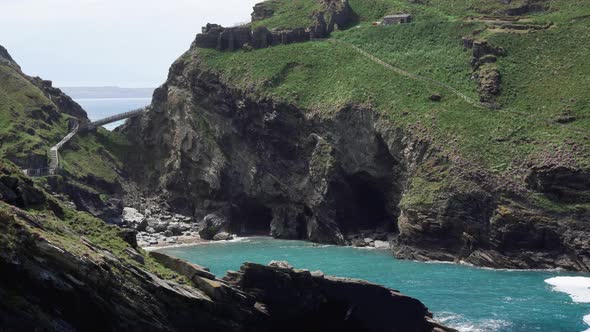 The ruins of  popular tourist destination Tintagel castle in Cornwall on top of a cliff with new bri alt