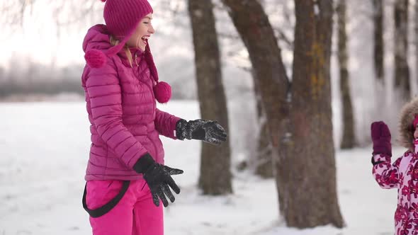 Young Mother and Little Daughter on the Snow