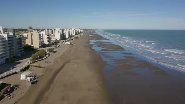 Aerial Drone view going up of empty beach with low tide, in Monte Hermoso, Argentina alt